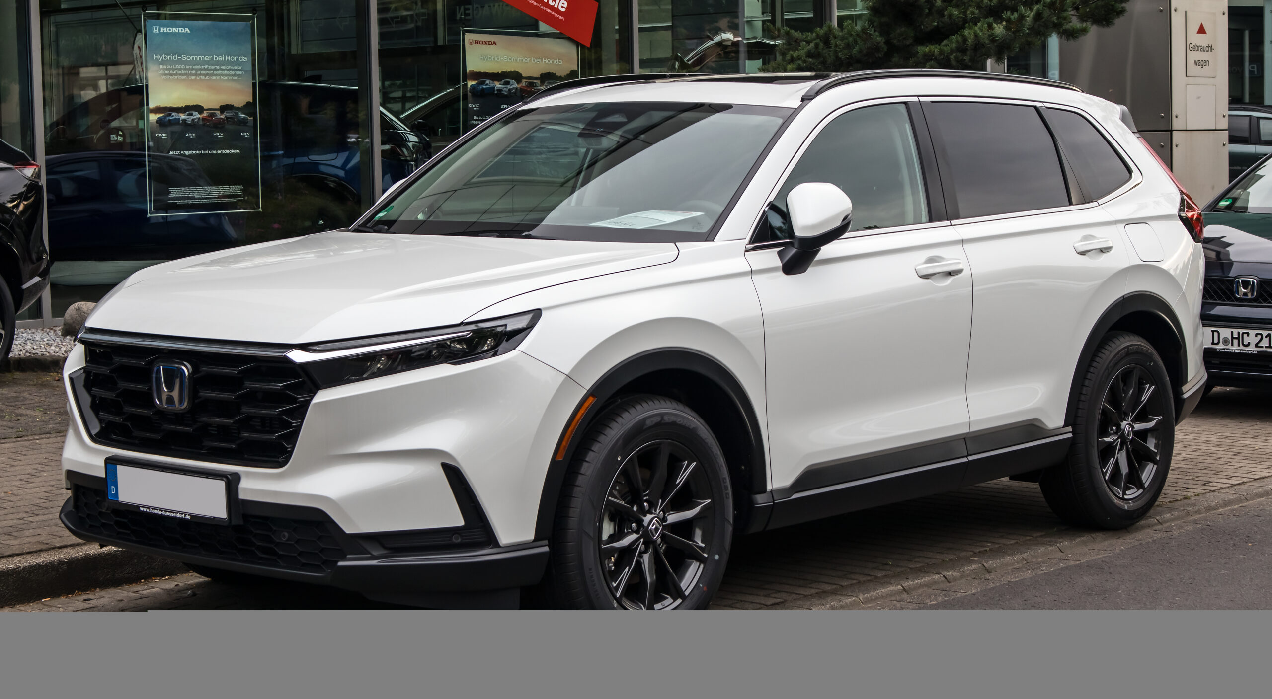 White sixth-generation Honda CR-V e:HEV parked in a front three-quarter view.