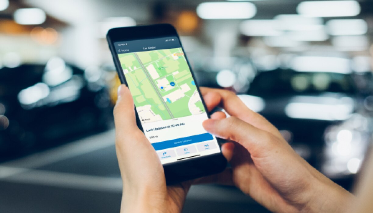 HondaLink vs CarPlay comparison with the HondaLink app shown on a phone near a Honda Pilot