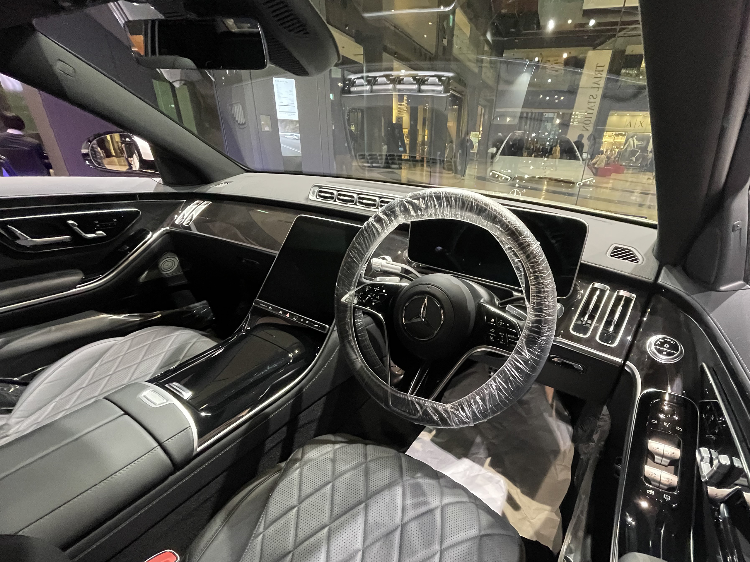 Mercedes-Benz S-Class interior showing the central display, digital dashboard area, and MBUX-style infotainment screen.