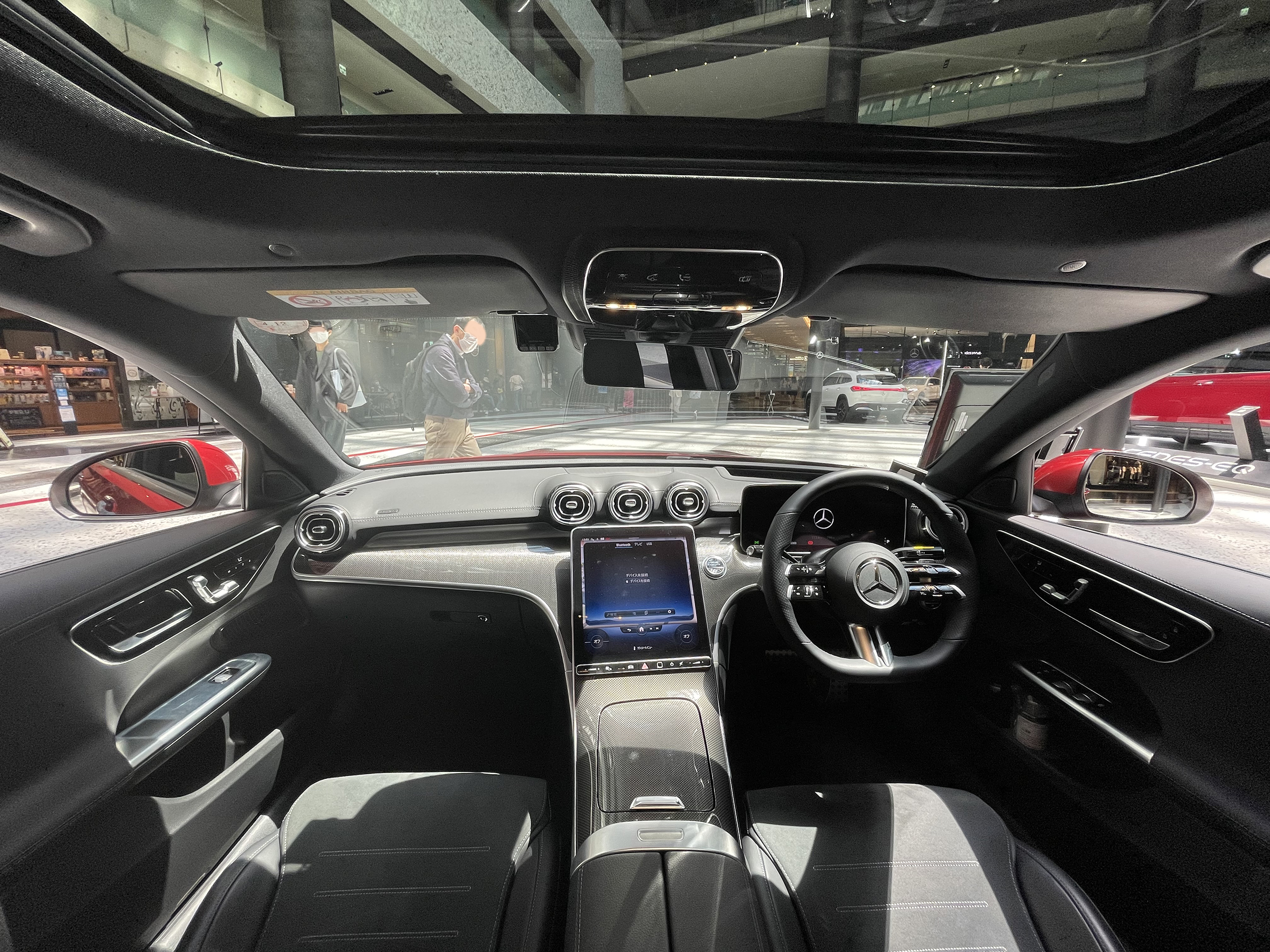Mercedes software update by model context shown on a Mercedes-Benz C-Class W206 interior with the infotainment screen and instrument display visible.