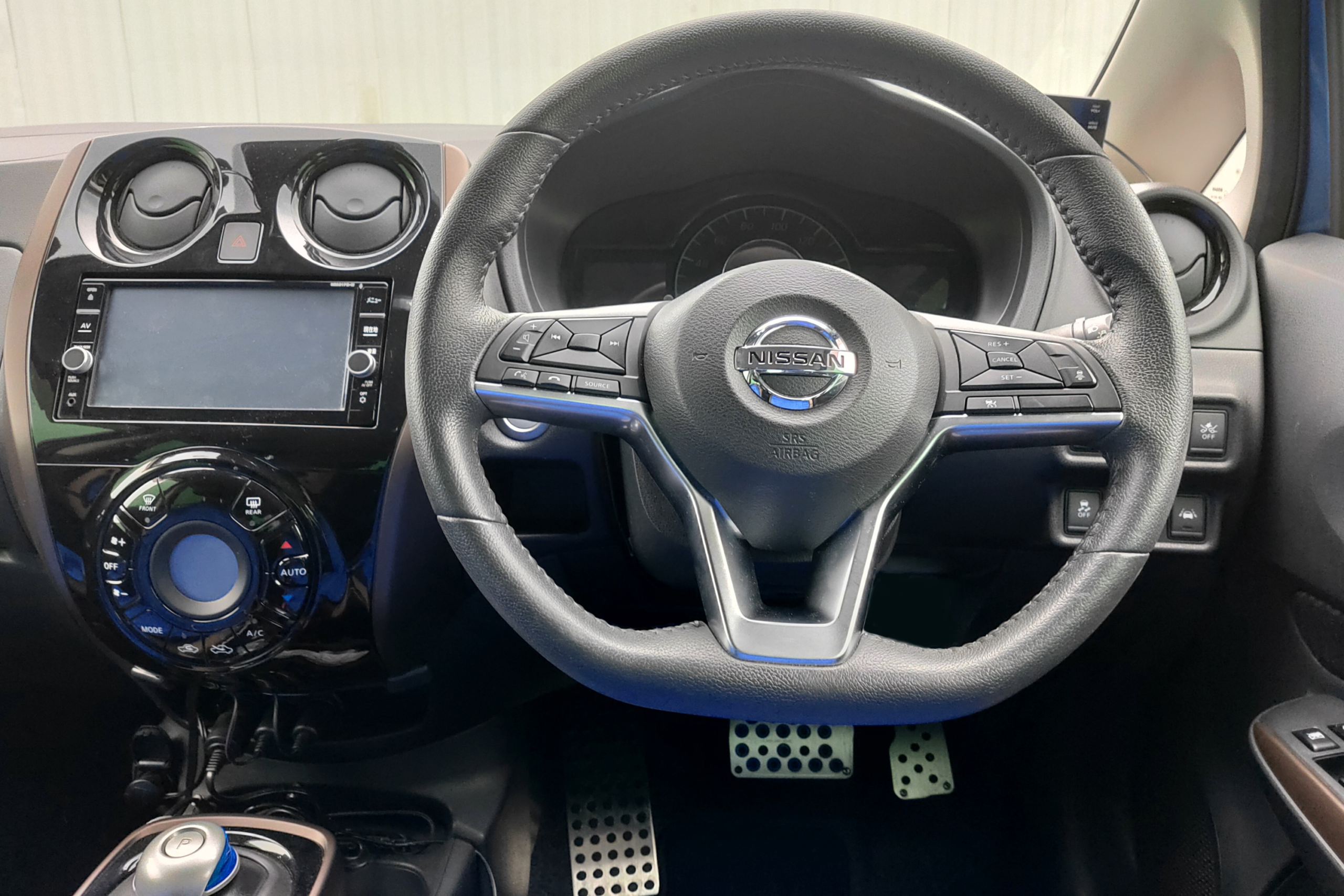Vehicle dashboard and driver controls inside a Nissan Note